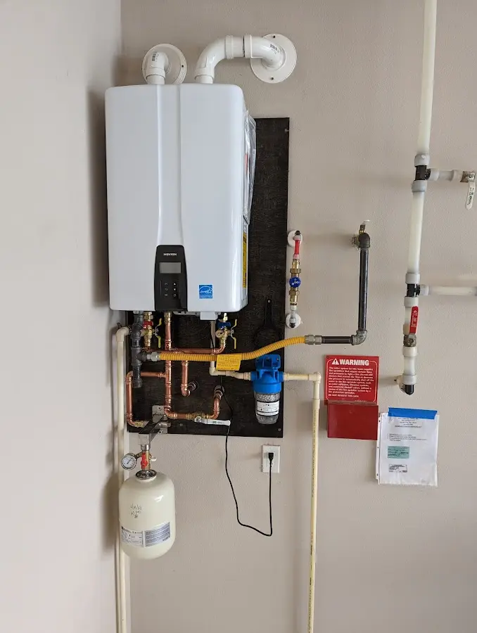 Professional plumber installing copper piping in a Lower Providence home
